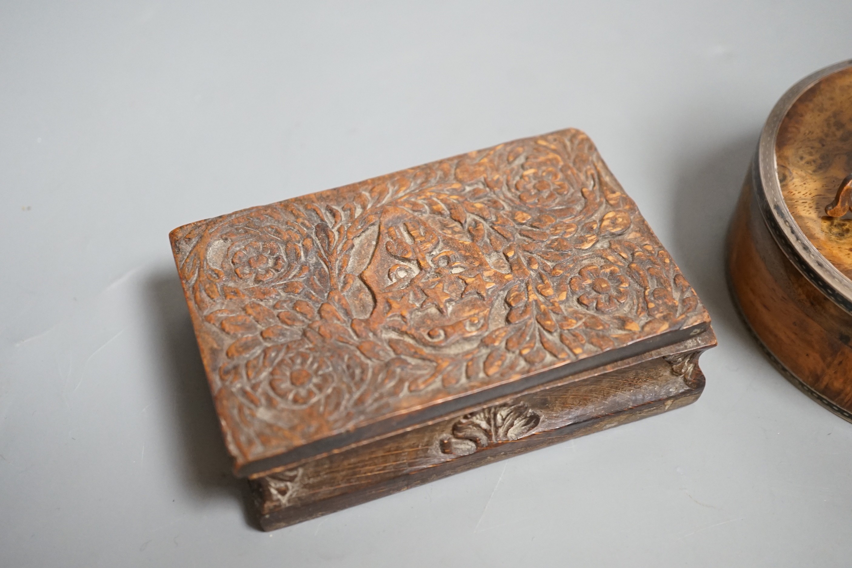 A 19th century circular white metal mounted burr wood snuff box and assorted small carvings